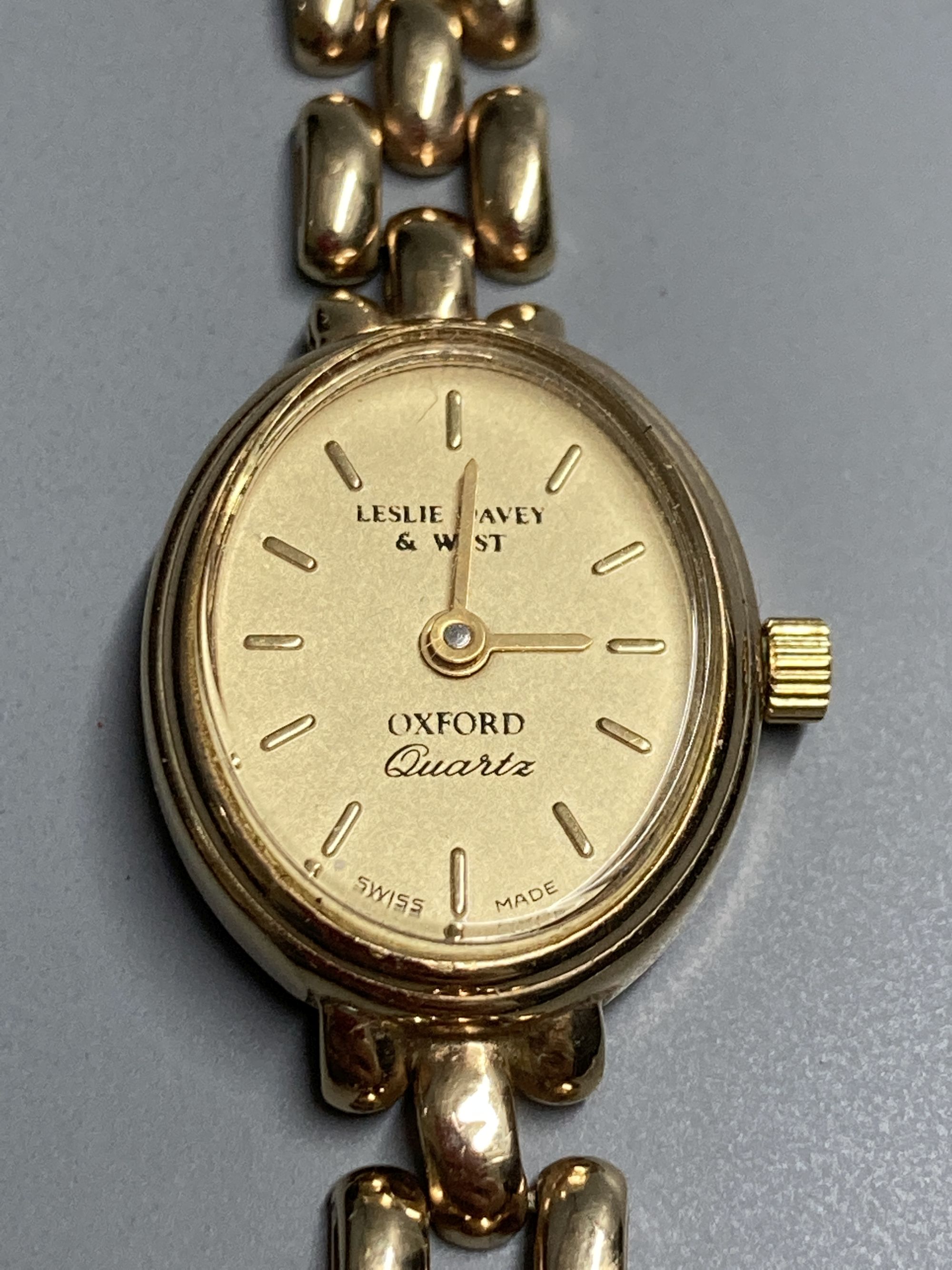 A ladys modern 9ct. gold quartz wrist watch with 9ct gold strap, gross 14.7 grams.